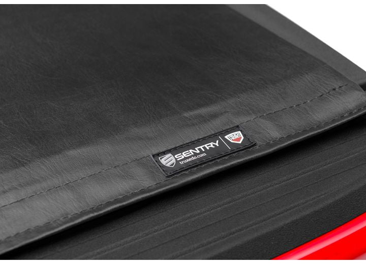 Close-up of the TruXedo name plate on the cover on a TruXedo Sentry hard roll-up tonneau cover