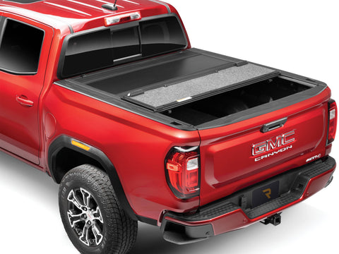 UnderCover Ultra Flex hard folding tonneau cover with the rear panel folded forward, rear three-quarter view