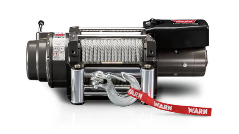 Warn 16.5ti winch, front elevation on white, showing the dark gray large-frame body, 7/16" wire rope on the drum, roller fairlead, latched hook with red Warn strap and the 16.5ti badge