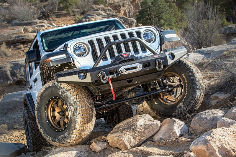 Warn Elite Front Bumper with Grille Guard Tube for 2020-2026 Jeep Gladiator / 2018-2026 Jeep Wrangler, on a Jeep Wrangler JL climbing rocks