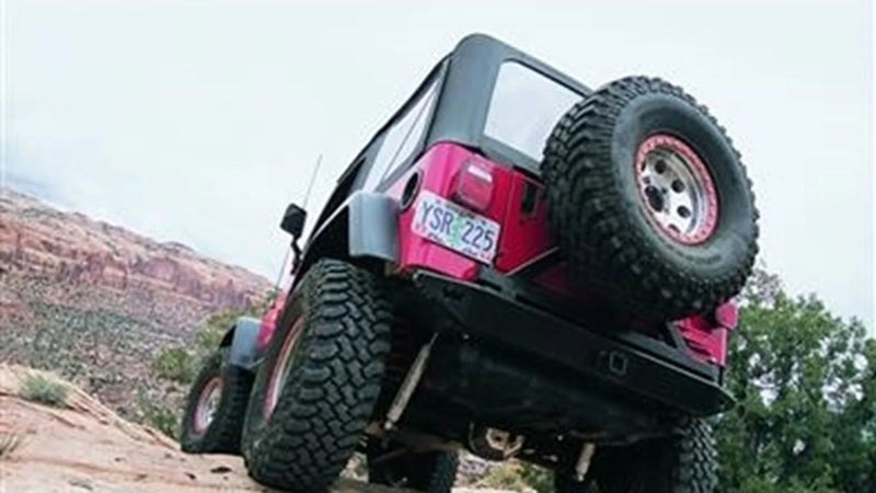 Warn Rock Crawler Rear Bumper for 1976-1983 Jeep CJ5 / 1976-1986 Jeep CJ7, on a Jeep CJ on the trail, seen from below