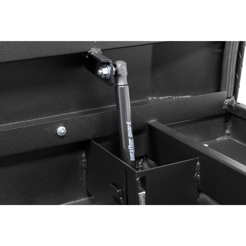 Weather Guard 121-52-04 crossover saddle box in textured matte black, close-up of the gas strut holding the lid open
