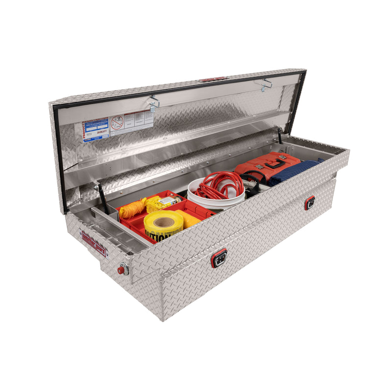 Weather Guard 127-0-04 crossover saddle box in bright aluminum diamond plate, staged open with hand tools inside to show how the usable space loads