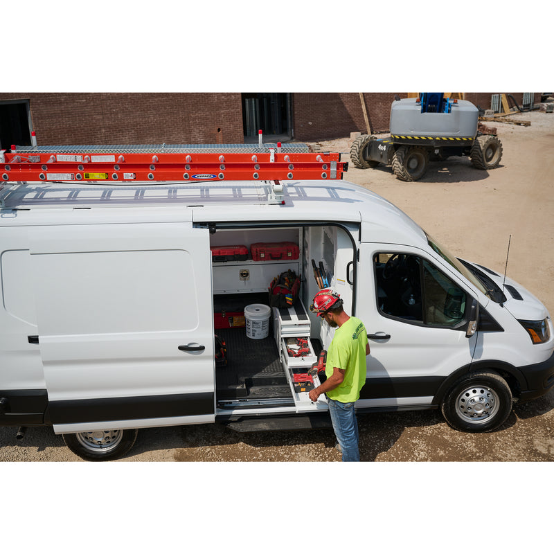 Technician at the open side door of a Ford Transit fitted with Weather Guard ITEMIZER drawers and a roof ladder rack at a jobsite