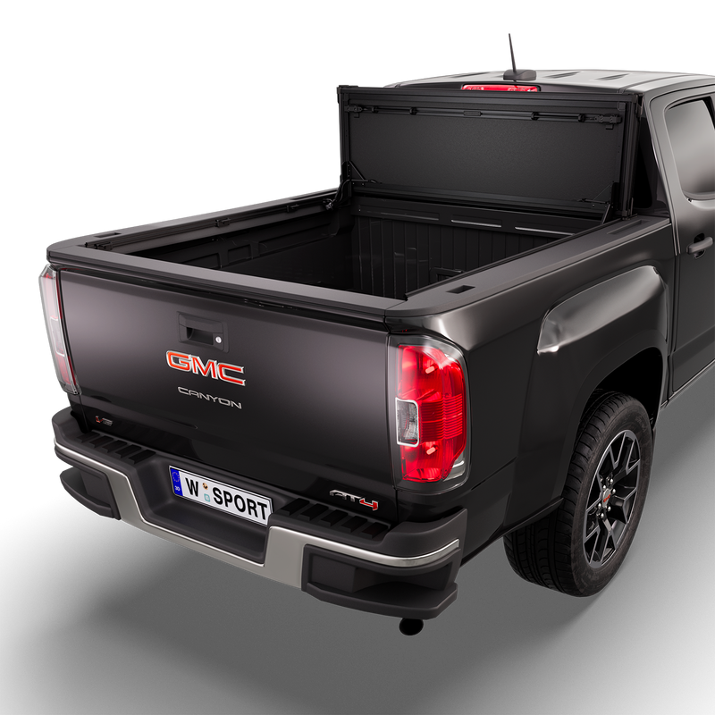 Worksport NEXUS hard folding tonneau cover on a pickup: 3D studio render of a black GMC Canyon from the rear quarter with a black NEXUS hard folding tonneau cover folded stack flipped up vertical against the cab, full bed open