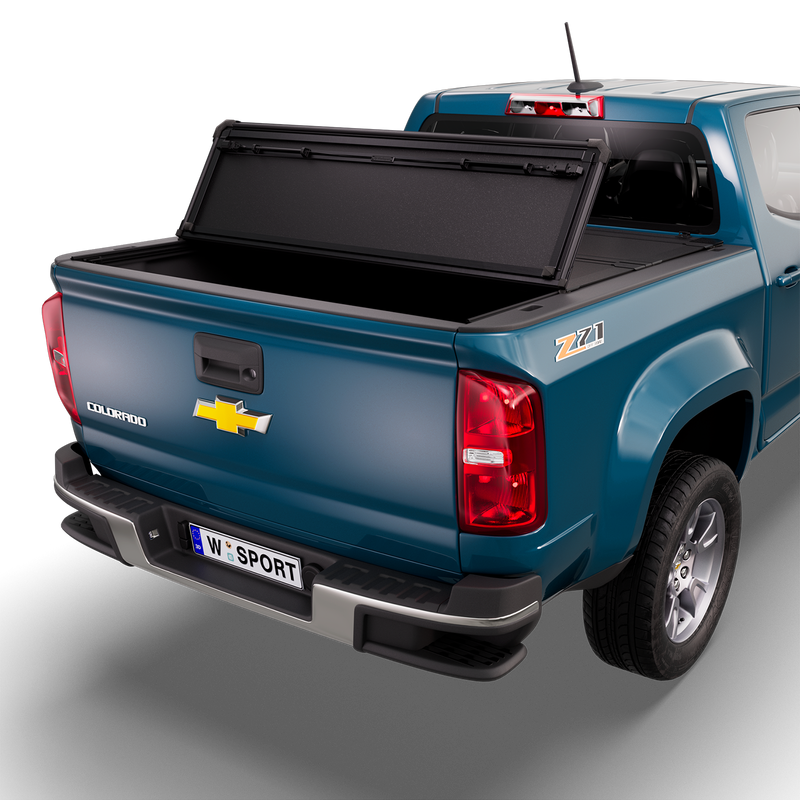 Worksport NEXUS hard folding tonneau cover on a pickup: 3D studio render of a blue Chevrolet Colorado from the rear quarter with a black NEXUS hard folding tonneau cover rear panel folded forward, one fold, rear of the bed open