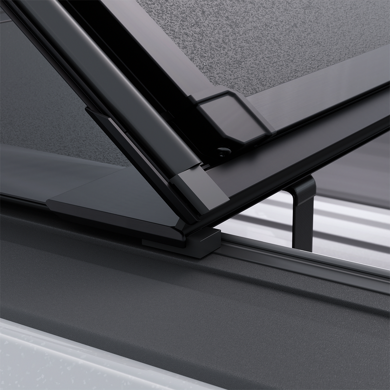 Close-up of the Worksport NEXUS hard folding tonneau cover: close-up render of a NEXUS panel edge lifting off its rail, showing the seal channel and dry cargo below