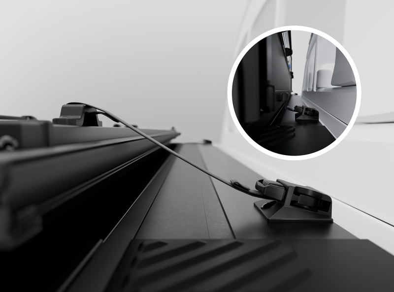 Close-up of the Worksport NEXUS hard folding tonneau cover: close-up render of the NEXUS release cable running to a rail latch on a white truck bed, with a circular inset of the rail clamp