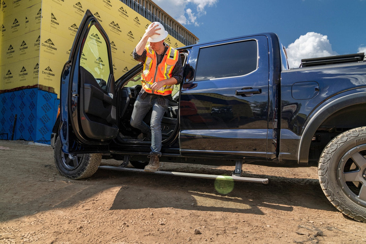 Blue 2021 Ford F-150 fitted with AMP Research PowerStep running boards