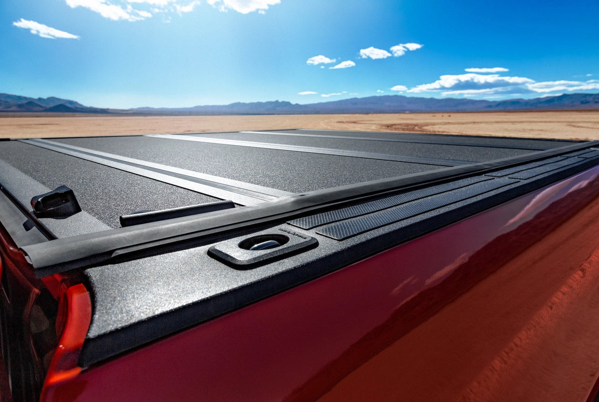 Red 2017 Toyota Tundra with a BAKFlip MX4 tonneau cover closed over the bed