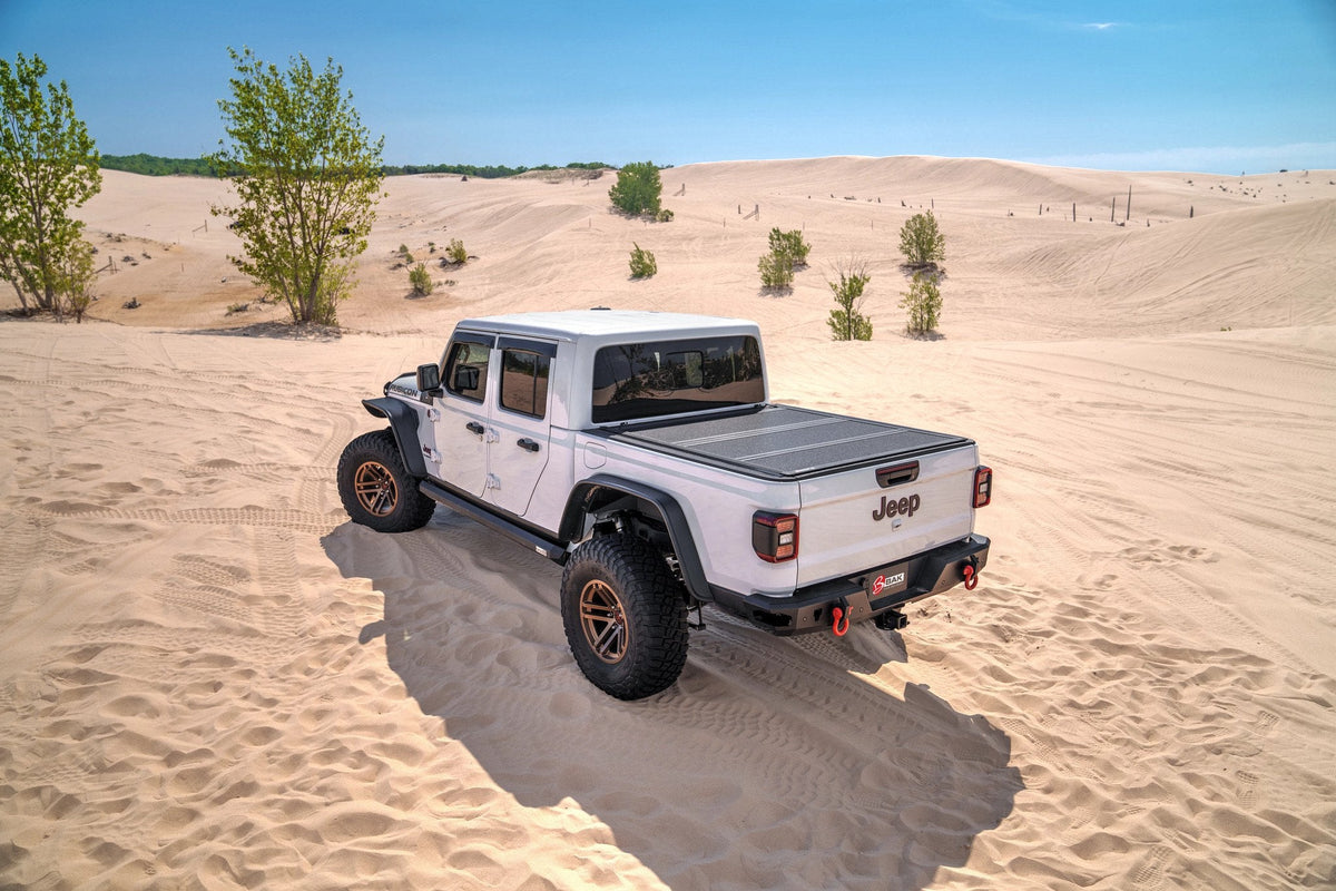 BAKFlip MX4 hard folding tonneau cover on a 2020 Jeep Gladiator parked on sand