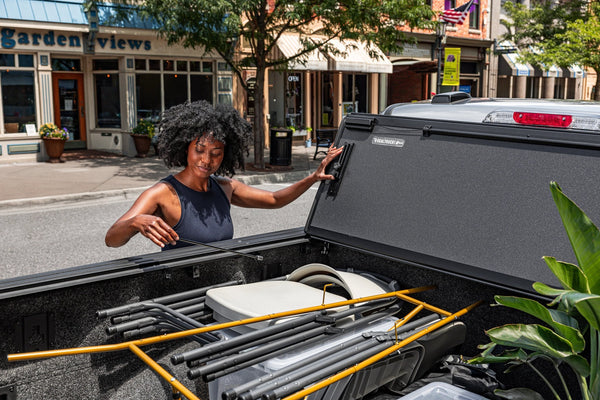 BAKFlip MX4 Gen 3 folded against the cab while cargo is loaded into a 2024 Ford F-150