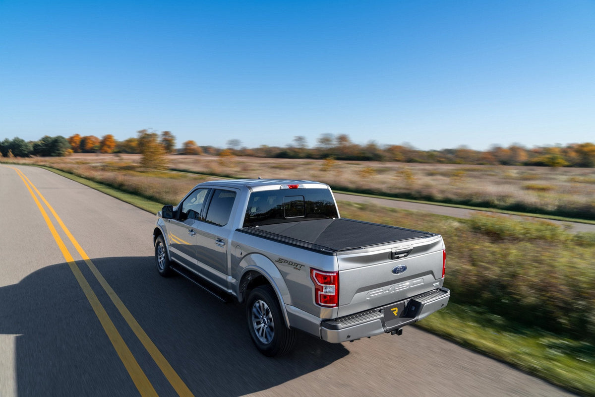 Gray 2020 Ford F-150 with a BAK Revolver X4s hard roll-up cover closed over the bed