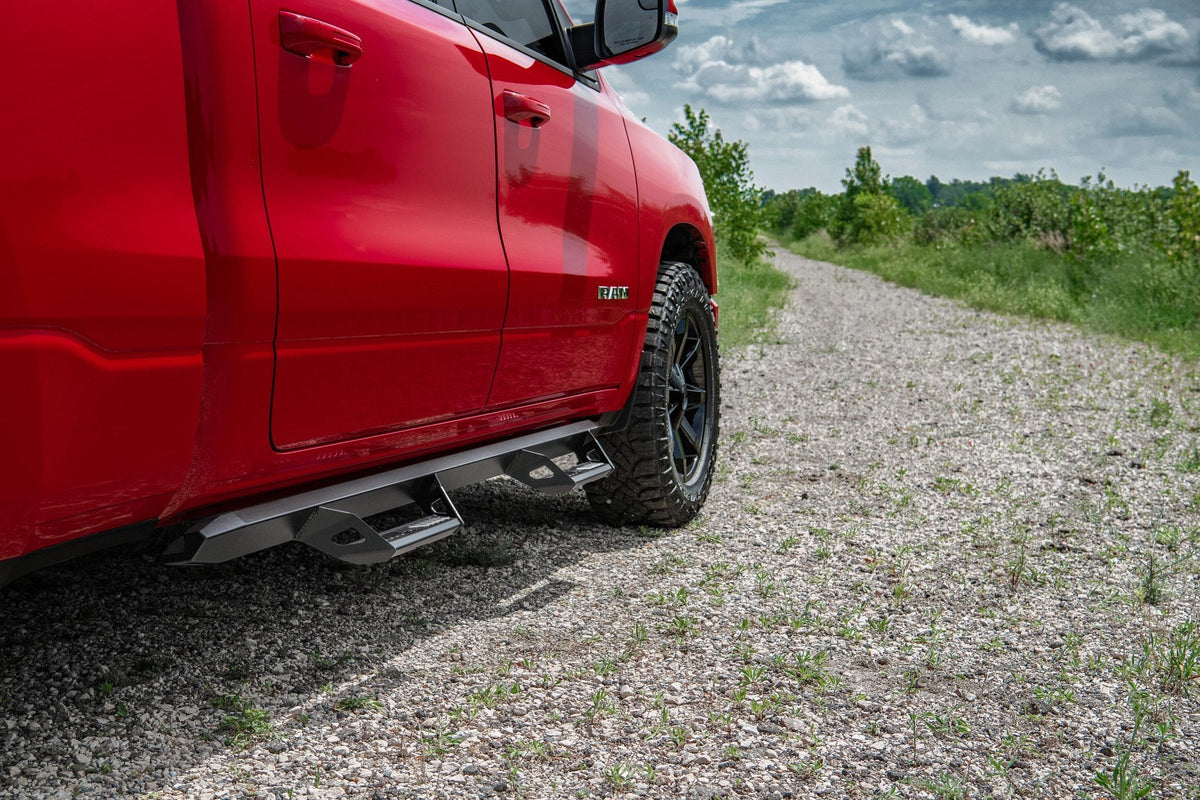 Red 2019 Ram 1500 with N-Fab Predator Pro nerf step bars installed