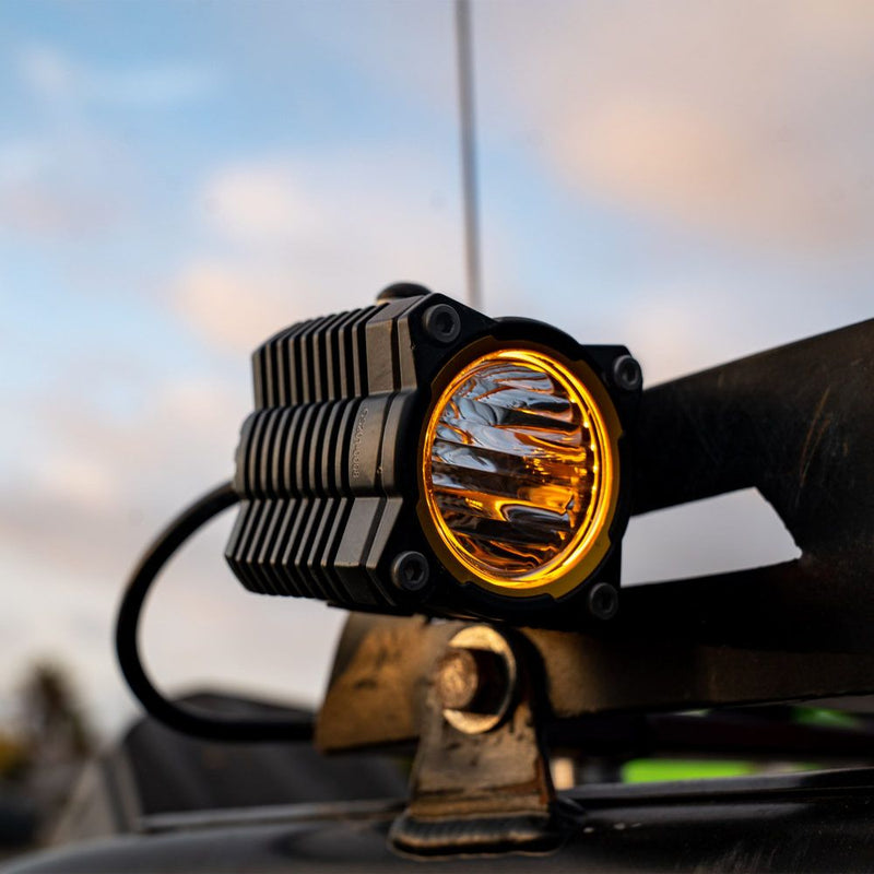 KC HiLiTES FLEX ERA 1 LED Light Pod Master Kit, lit FLEX ERA 1 pod light on a vehicle mount at sunset