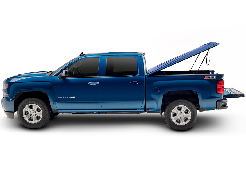 UnderCover LUX one-piece tonneau cover raised with the tailgate down, full side profile with the box open along its whole length.