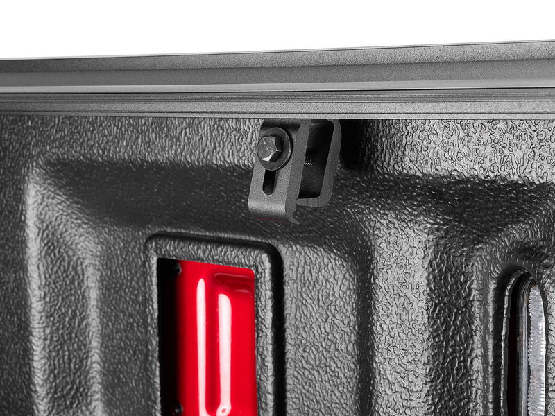 Close-up of the Select rail-mount bracket and bolt beneath the bed rail, seen from inside the bed.