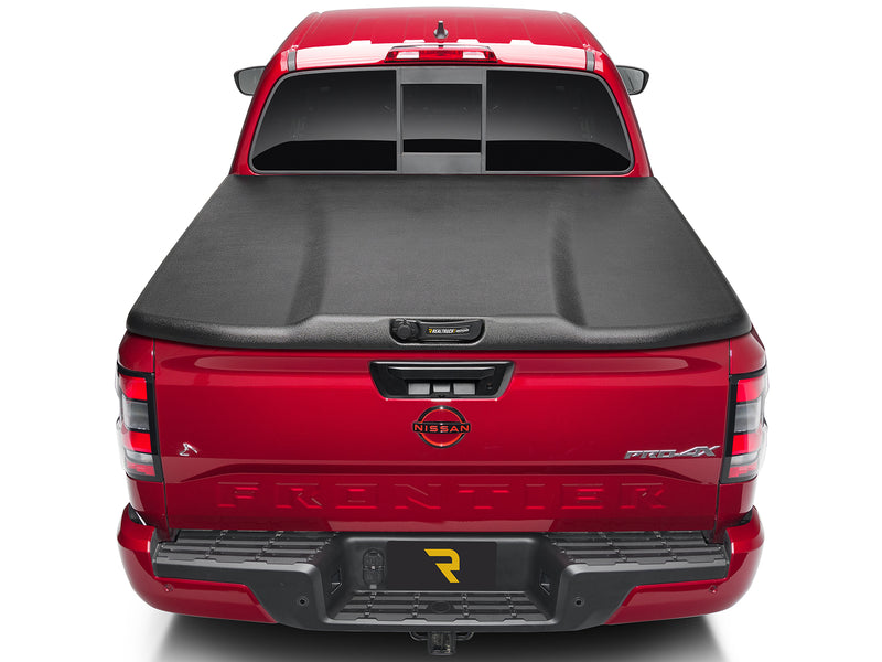 UnderCover Elite one-piece tonneau cover closed and latched, straight rear view showing the whole lid and both bed rails square to the camera.