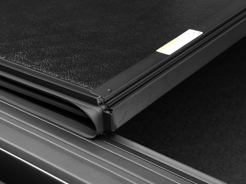 Close-up of the panel-to-panel hinge joint on the closed ArmorFlex cover, showing the molded hinge cap and textured panel finish.