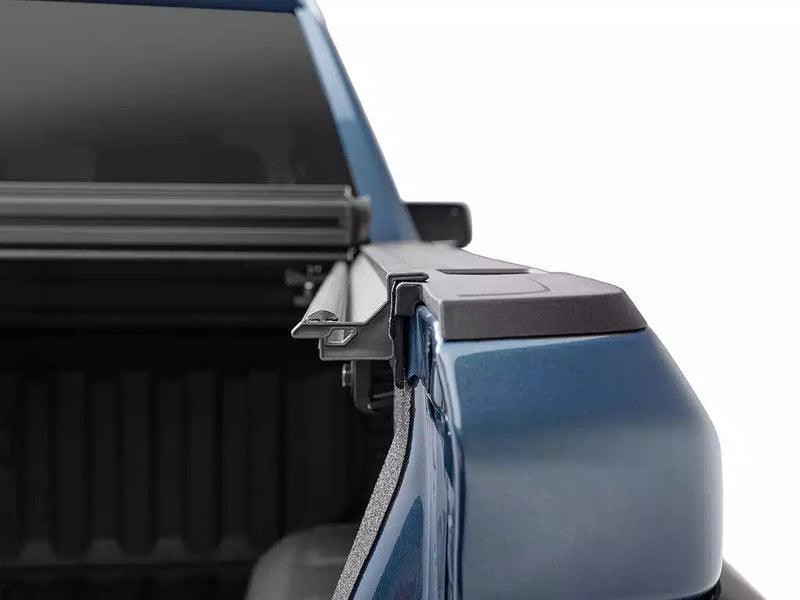 Close-up of the Select cover's front corner, molded end cap and rail bracket at the bulkhead.