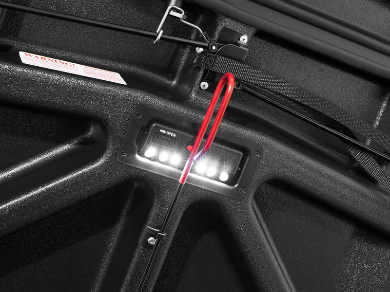 Close-up of the lit LED light module recessed into the black textured underside of the Elite lid.