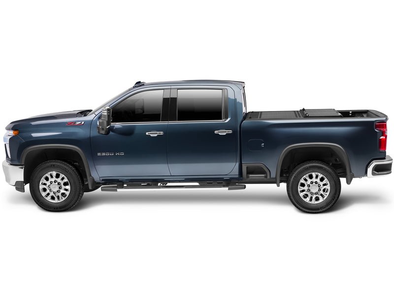 UnderCover Flex hard folding tonneau cover part-open with the rear panel folded forward, full side profile showing the rear third of the bed exposed.