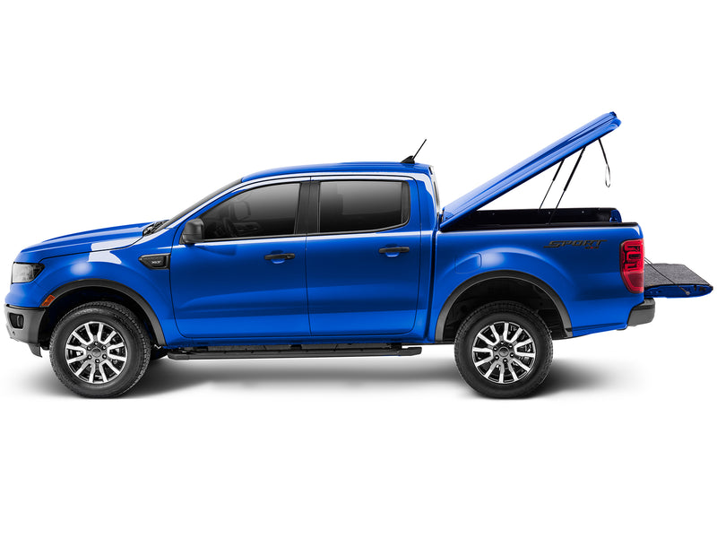 UnderCover Elite LX one-piece tonneau cover raised with the tailgate down, full side profile, the box open along its whole length.