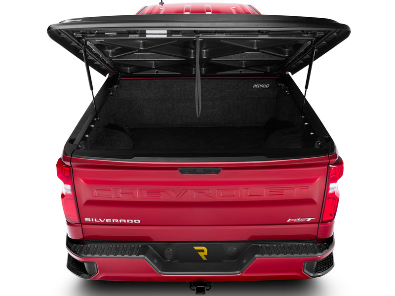 UnderCover SE one-piece tonneau cover raised, straight rear view looking at the X-brace underside of the lid and into the open box.