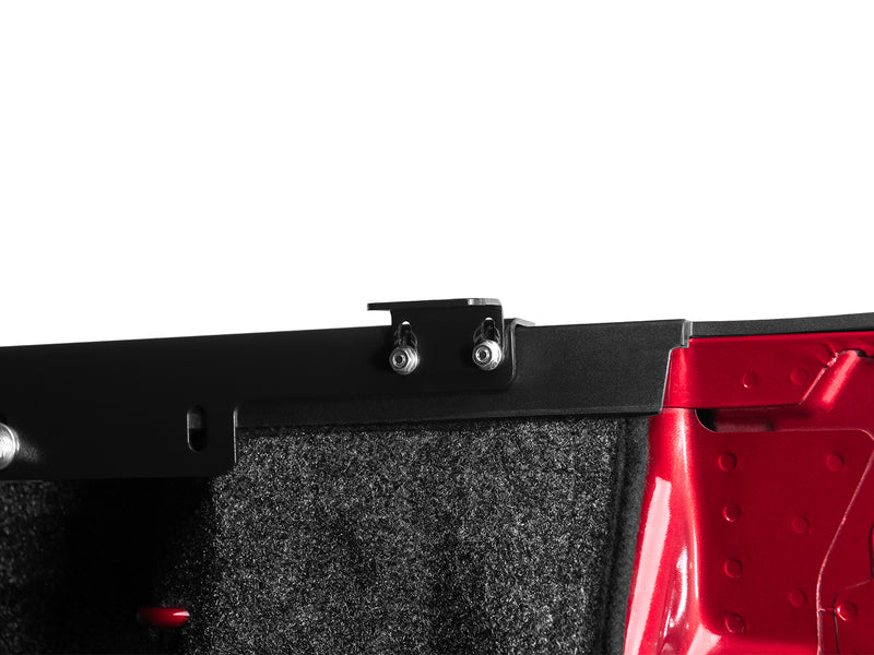 Close-up of the black SE mounting rail clamped down over the inside of the bed wall.