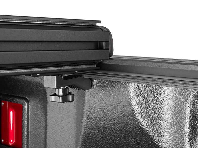 Close-up of the Select panel hinge line and rail clamp with the cover folded forward.