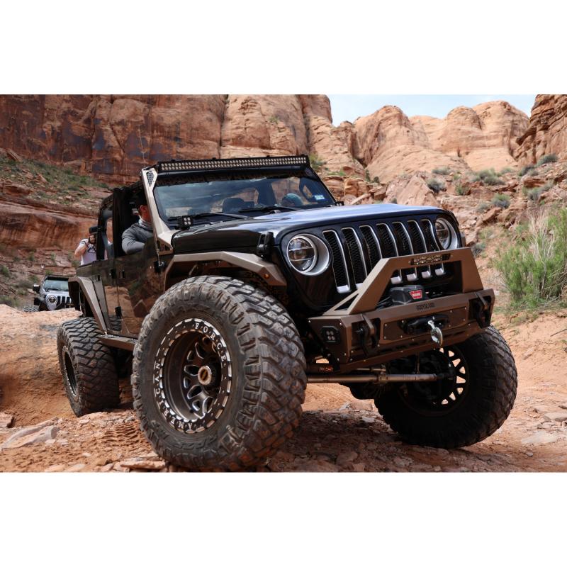 Rigid SR-Series PRO light bar installed in the bumper of a black Jeep Wrangler on desert rocks