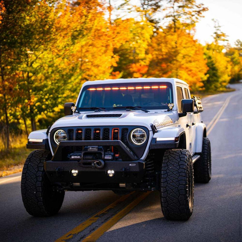 KC HiLiTES FLEX ERA 3 Dual-Mode SAE Fog Light Kit, Steel Bumper, Jeep Wrangler on a fall road with its fog lights on