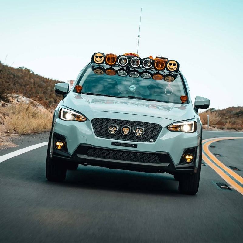 KC HiLiTES FLEX ERA 3 Dual-Mode SAE Fog Light Kit, Subaru Crosstrek on a mountain road with fog lights fitted