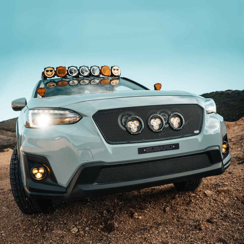 KC HiLiTES FLEX ERA 3 Dual-Mode SAE Fog Light Kit, front of a lifted Subaru Crosstrek with the fog lights in the bumper