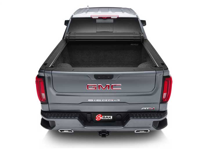 2019-2026 Chevrolet Silverado / GMC Sierra 1500 with the BAK Revolver X4s hard roll-up tonneau cover, rear head-on, cover rolled open for full bed access
