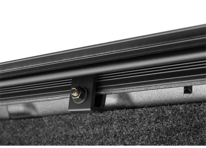 2019-2026 Chevrolet Silverado / GMC Sierra 1500 with the BAK Revolver X4s hard roll-up tonneau cover, close-up of the no-drill clamp