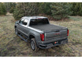 2019-2026 Chevrolet Silverado / GMC Sierra 1500 with the BAK Revolver X4s hard roll-up tonneau cover, studio three-quarter view, cover closed