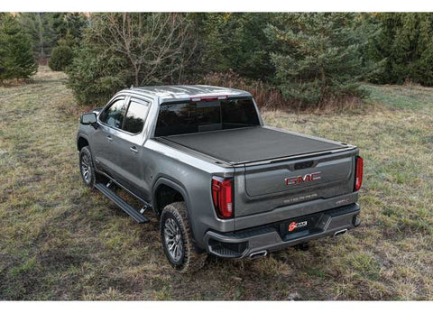 2019-2026 Chevrolet Silverado / GMC Sierra 1500 with the BAK Revolver X4s hard roll-up tonneau cover, studio three-quarter view, cover closed