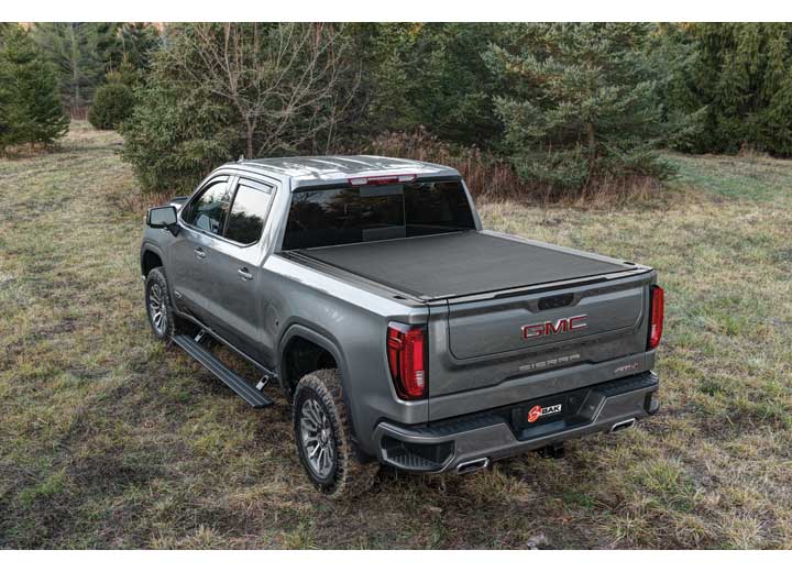 2019-2026 Chevrolet Silverado / GMC Sierra 1500 with the BAK Revolver X4s hard roll-up tonneau cover, studio three-quarter view, cover closed