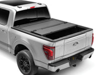 BAKFlip MX4 hard folding tonneau cover partially folded open over a truck bed