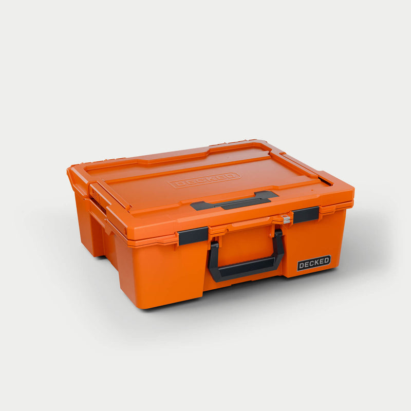 Blaze Orange DECKED Halfrack 32 D-co case closed, three-quarter studio view showing the black bail handle and clutch latches