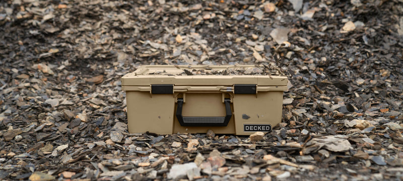 Desert Tan DECKED Halfrack 32 closed on dark shale rock outdoors