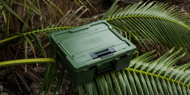 Ranger Green DECKED Halfrack 32 closed, resting on palm fronds in tropical brush