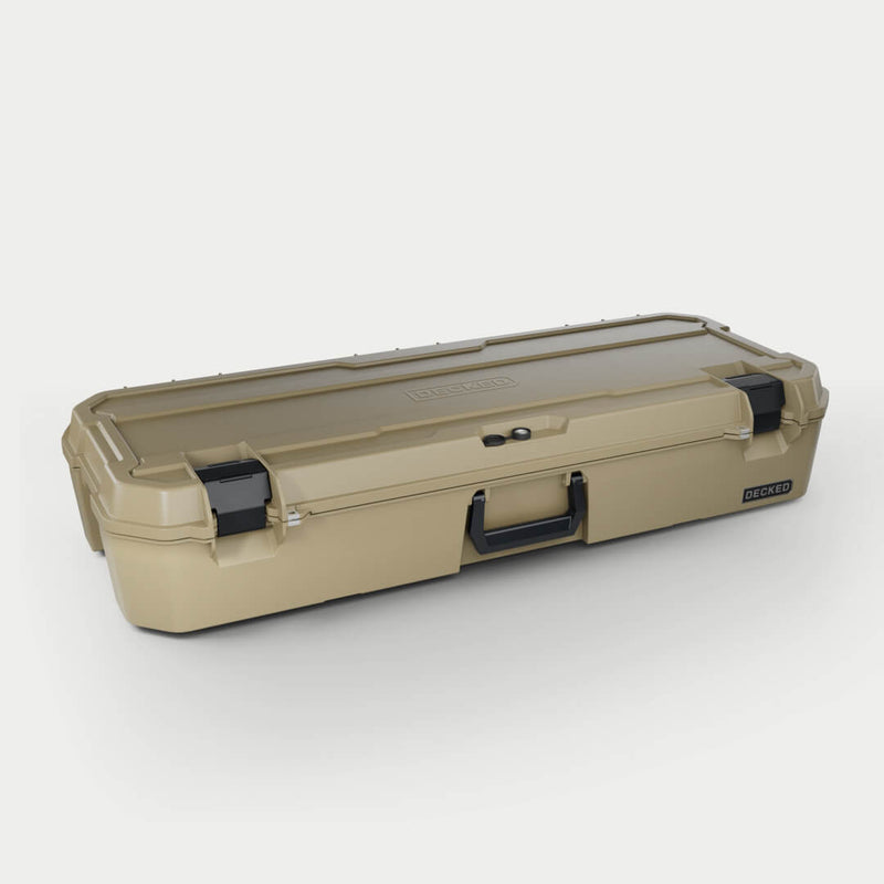 Desert Tan DECKED Honcho 80 D-co case closed, three-quarter studio view showing the long profile, bail handle and cam latches