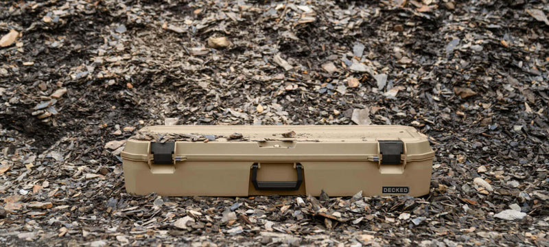 Desert Tan DECKED Honcho 80 closed on shale scree outdoors