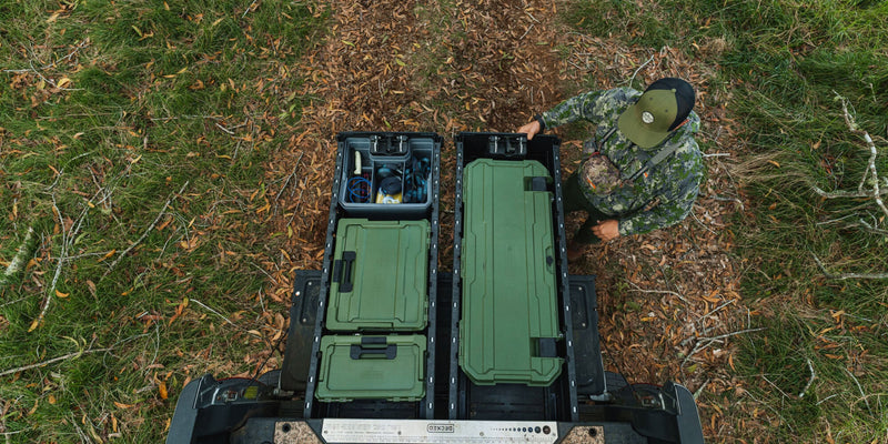 Overhead view of a Ranger Green DECKED Honcho 80 and a smaller green case stowed in an open DECKED Drawer System