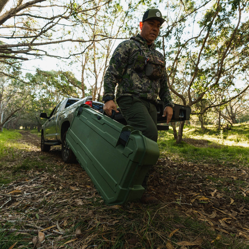 Hunter lifting a Ranger Green DECKED Honcho 80 out of a pickup fitted with a DECKED Drawer System