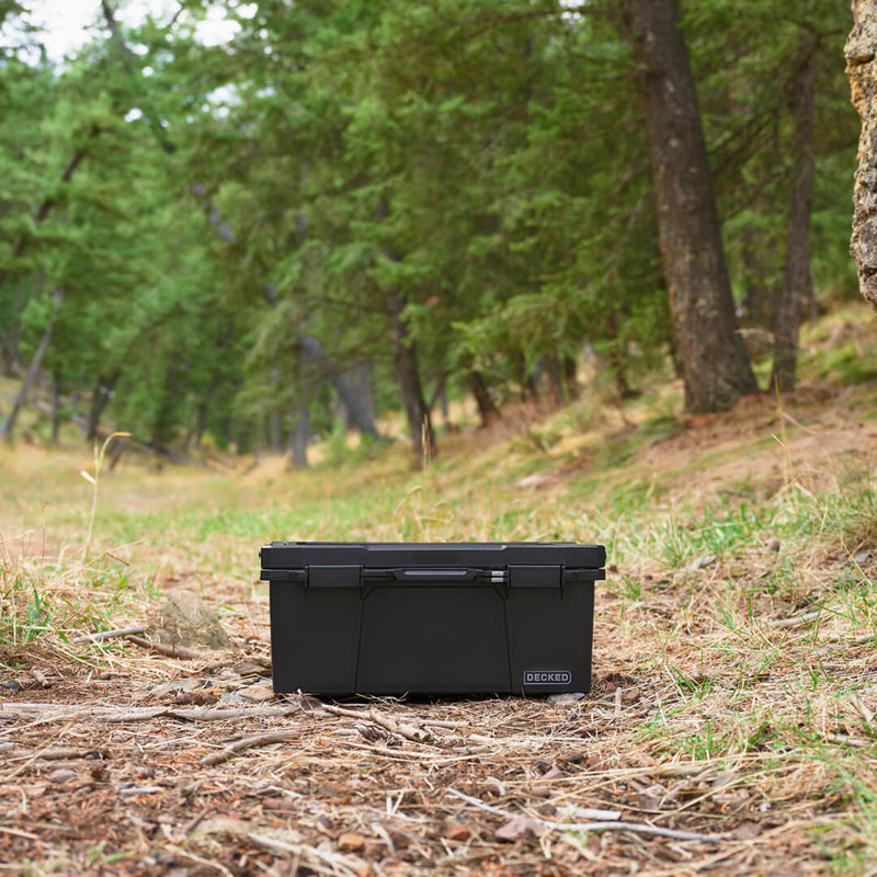 Black DECKED Sixer 16 closed on the forest floor among fallen timber