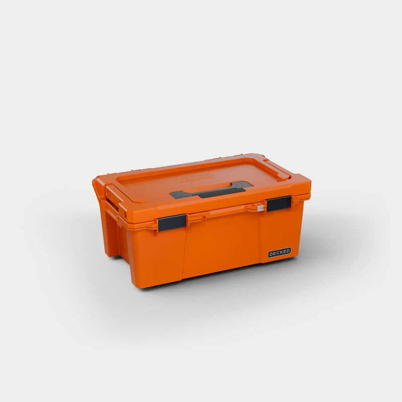 Blaze Orange DECKED Sixer 16 D-co case closed, three-quarter studio view showing the lid handle and black clutch latches