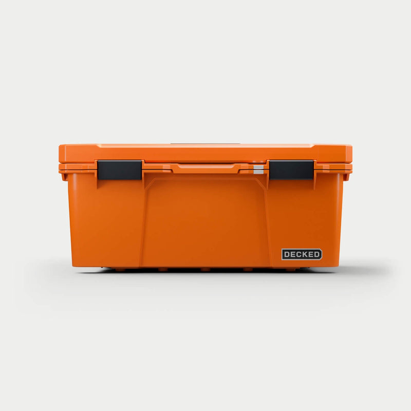 Straight-on front view of the closed Blaze Orange DECKED Sixer 16 showing the lid gasket line and both latches